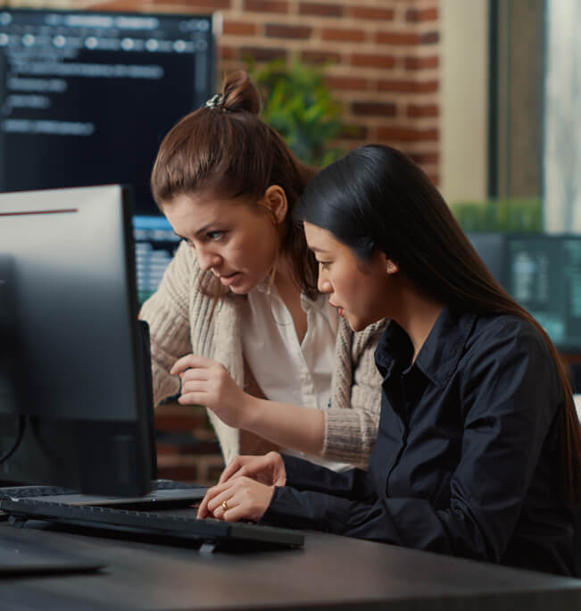 Two women looking at a screen doing manage it services
