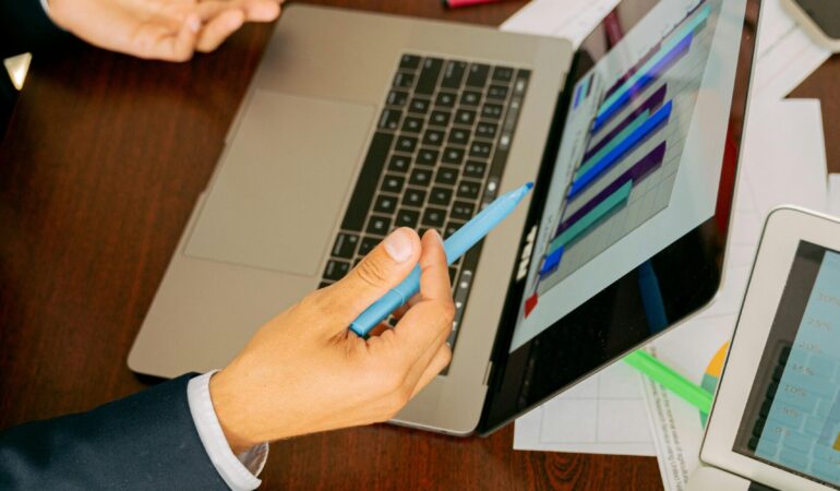 Free A Person in Black Suit Holding a Pen Stock Photo