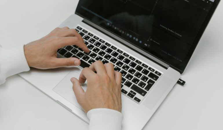 Free Hands on a Laptop Keyboard Stock Photo