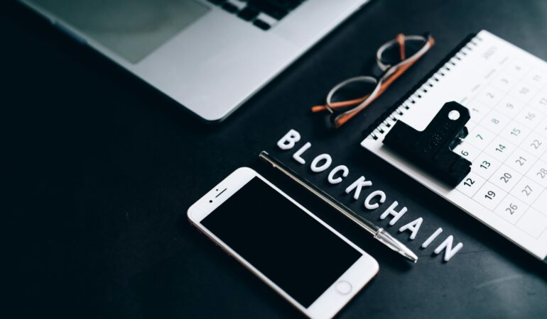 Free Flat lay of a modern digital workspace with blockchain theme, featuring a smartphone and calendar. Stock Photo