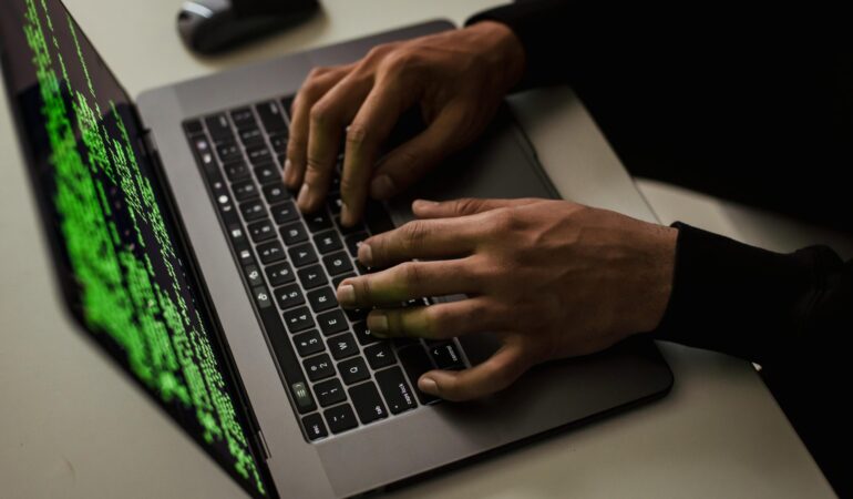 crop-cyber-spy-hacking-system-while-typing-on-laptop