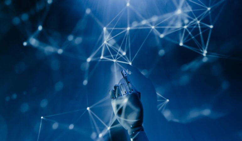 Free A robotic hand reaching into a digital network on a blue background, symbolizing AI technology. Stock Photo